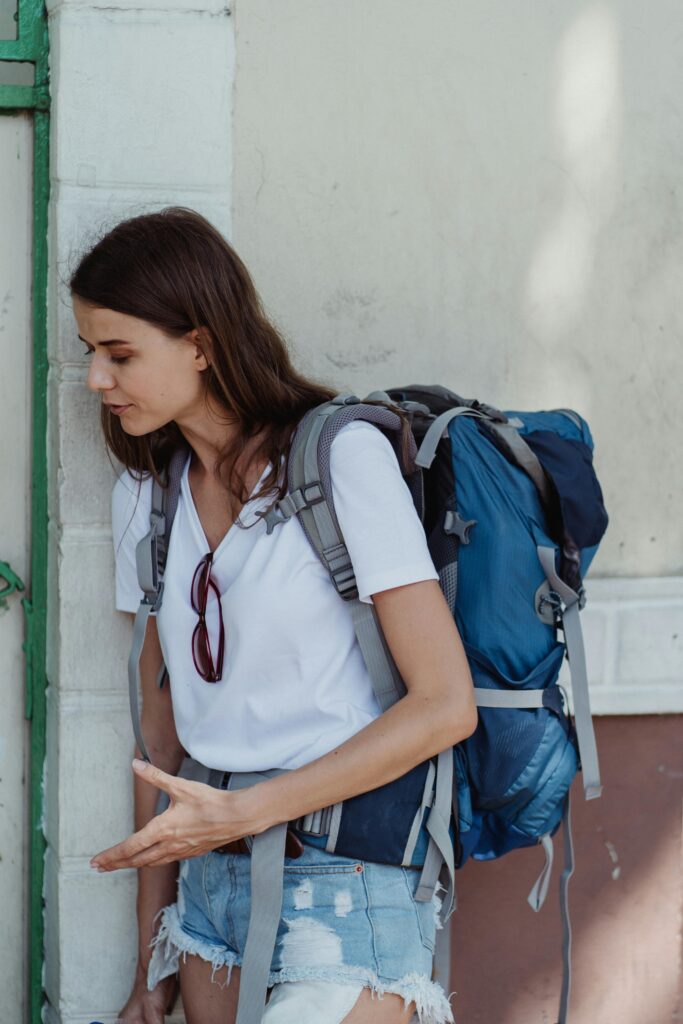 Adventure awaits a young woman traveler with a backpack enjoying the outdoors.