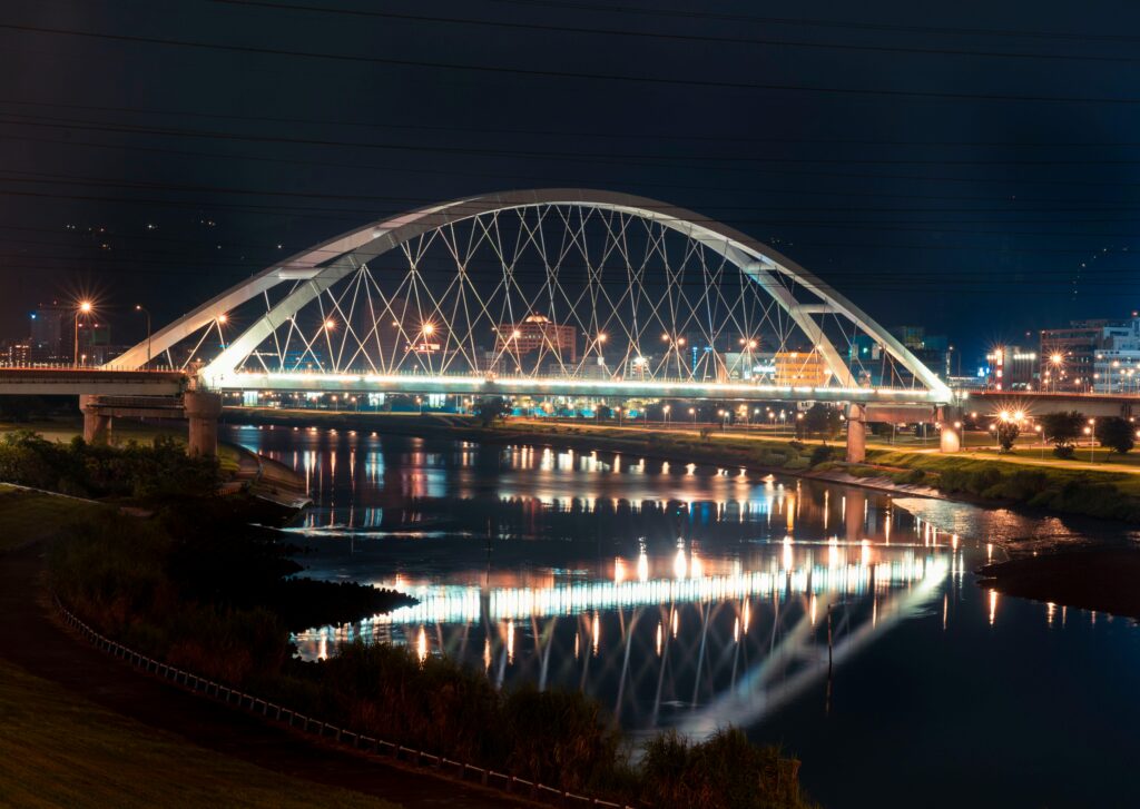 A stunning nighttime view of the Walterdale Bridge with its reflection on the river.