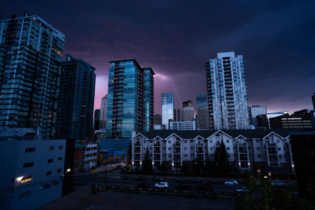 A striking cityscape of Calgary at night with lightning illuminating the skyline.