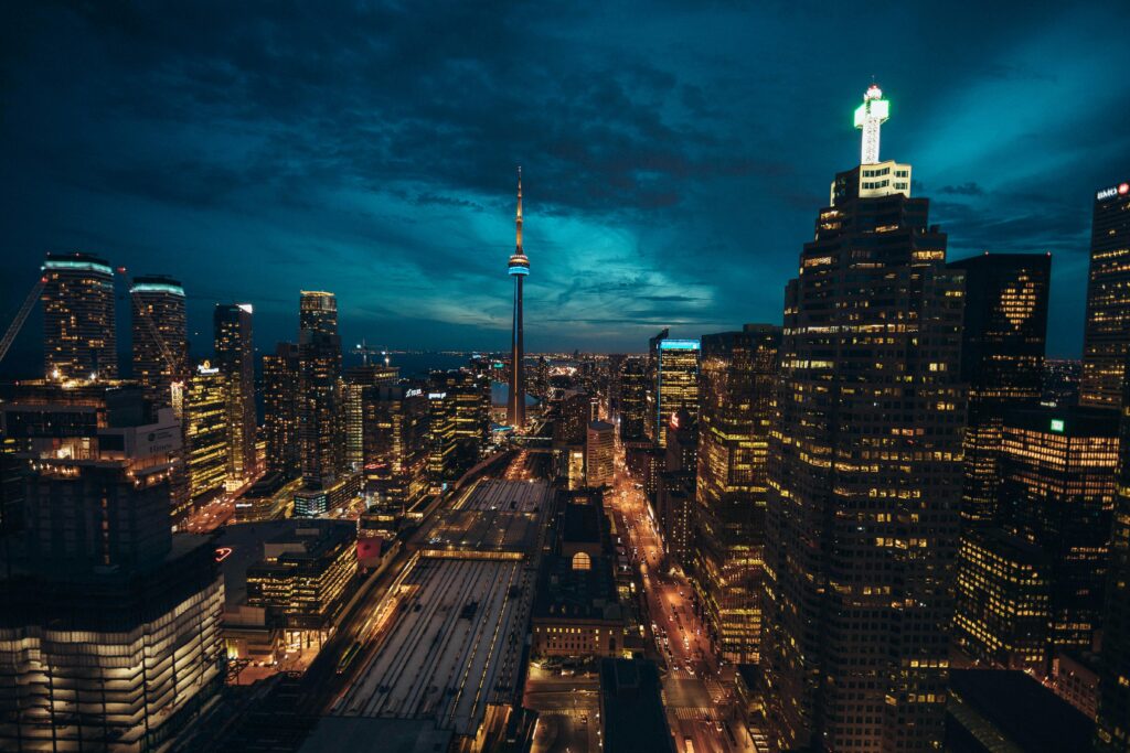 Stunning Toronto cityscape at night featuring the illuminated CN Tower and vibrant urban skyline.